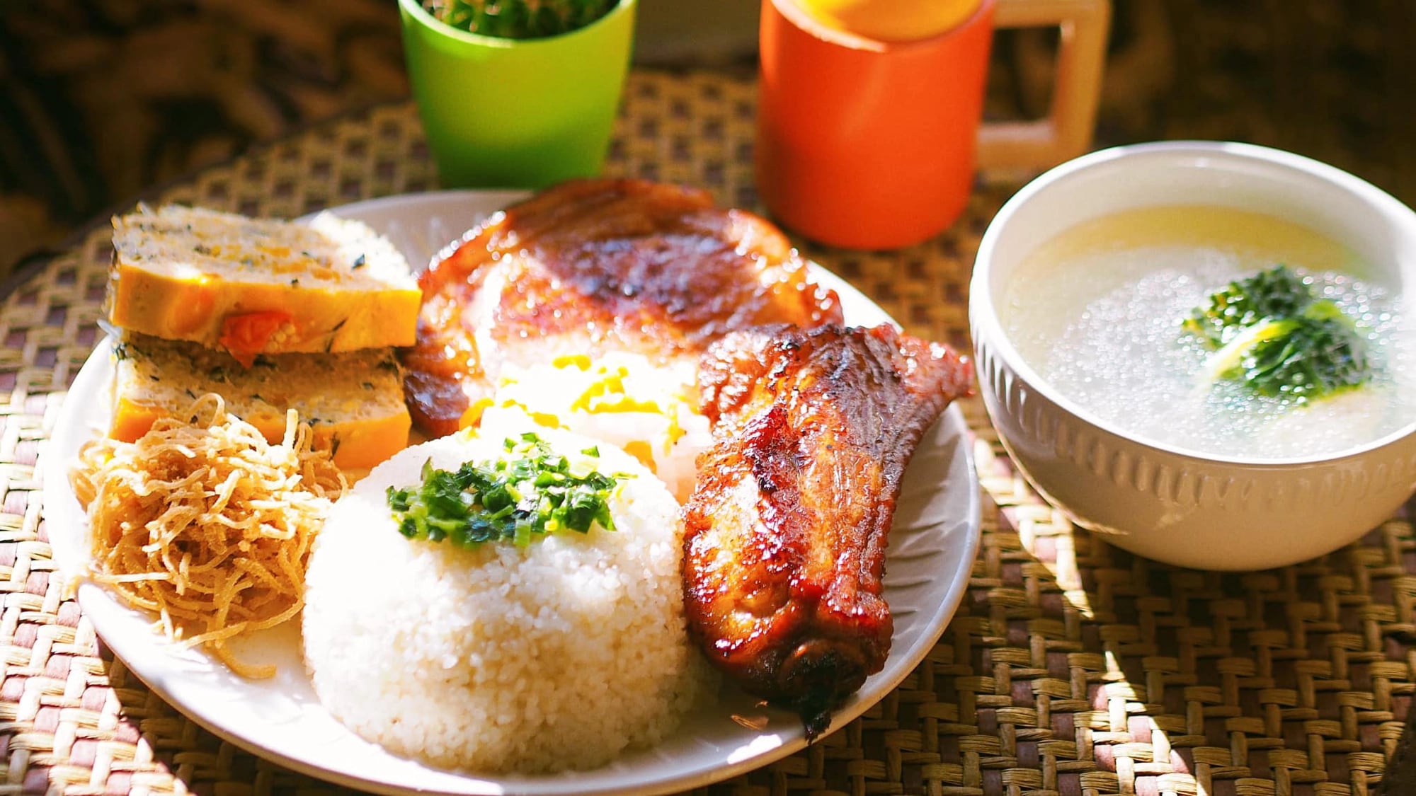 Plate of broken rice with grilled pork and pickled vegetables